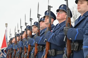 Policjanci trzymają broń.