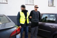 Policjant z zatrzymanym przy samochodzie