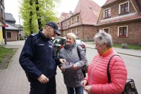 Dzielnicowy wręcza ulotki mieszkankom Rudy Śląskiej