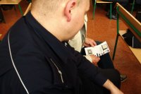 Dzielnicowy rozmawia z uczestnikiem spotkania