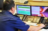 zdjęcie kolorowe - dyżurny policji na stanowisku kierowania