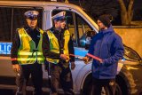 policjanci z drogówki i pieszy, który dostaje odblaski