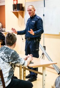policjant w trakcie spotkania z licealistami