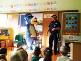 Policjant z maskotką śląskiej policji Sznupkiem w przedszkolu - zdjęcie archiwalne