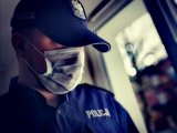 policjant w czapce i z maseczką na twarzy