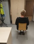 widok osoby siedzącej na krześle odwróconej tyłem