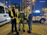 zdjęcie przedstawia policjanta i dwie osoby stojące obok
