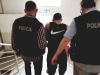 policjanci prowadzą zatrzymanego