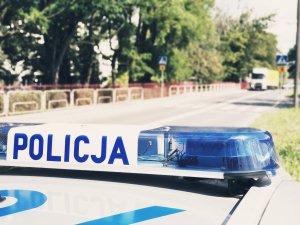 radiowóz przy szkole, w tle pasy