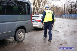 zdjęcie ilustracyjne - policjant, samochód typu bus, radiowóz policyjny