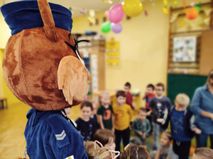 maskotka sierżant Ruda w sali pełnej przedszkolaków