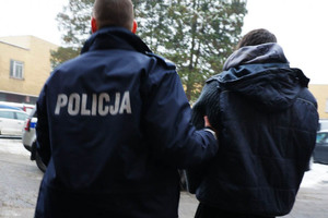 zdjęcie poglądowe - policjant prowadzi zatrzymanego