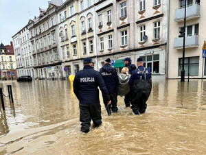 zdjęcie pokazujące policjantów pomagających ludności - zalane ulice miasta