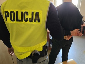 zdjęcie archiwalne pokazujące policjanta z zatrzymanym