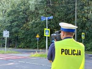 Policjant ruchu drogowego z miernikiem prędkości podczas działań