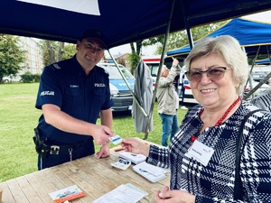 Dzielnicowy wręcza kartę seniorce