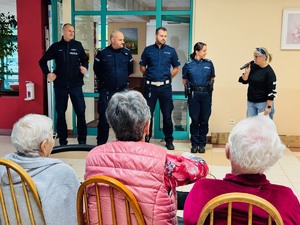 zdjęcie z debaty w domu pomocy społecznej przedstawia pracownicę domu pomocy społecznej przedstawiającą policjantów