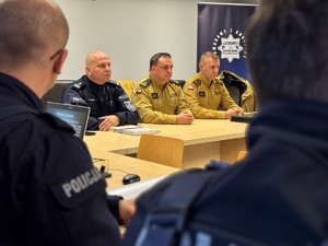 zdjęcie przedstawia siedzących zastępców komendanta policji, straży pożarnej i rzecznika strażaków