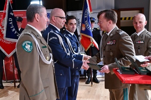 zdjęcie przedstawiające wręczenie medalu rudzkiemu policjantowi przez komendanta śląskiego oddziału straży granicznej