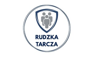Logo programu rudzka tarcza, które przestawia symbol ludzi w tarczy, poniżej znajduje się napis nazwy programu. Całość jest zamknięta w okrąg.